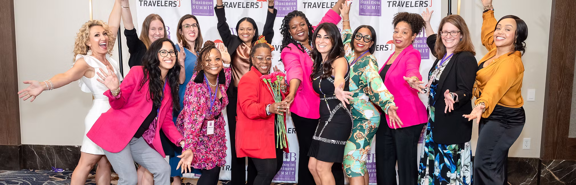 Tisha Zullo (in pink coat, center) with some previous participants of the Women in Business Summit.
